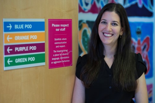 Bailey with signs for the different coloured pods in the Sears Cancer Clinic