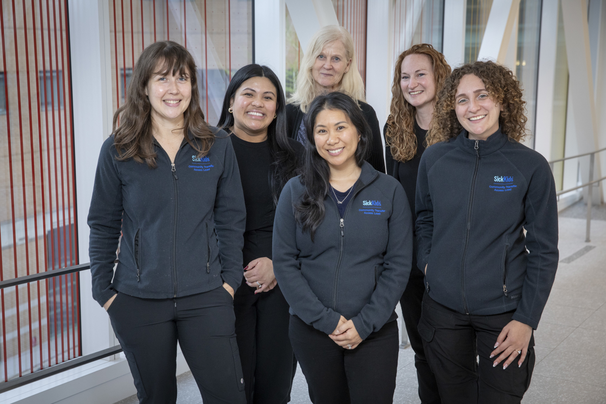 picture of CTAL team standing together in a bright corridor with railings in the background. 